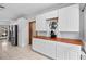 Bright kitchen featuring white cabinetry, wood countertops, stainless steel appliances, and a charming coffee bar at 7024 Sw 93Rd Street Rd, Ocala, FL 34476