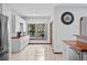 Bright kitchen area featuring white cabinets, stainless steel refrigerator, and butcher block countertops at 7024 Sw 93Rd Street Rd, Ocala, FL 34476