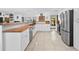 Modern kitchen features stainless steel appliances, white cabinets, and butcher block countertops at 7024 Sw 93Rd Street Rd, Ocala, FL 34476