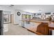 Open-concept kitchen featuring wood countertops, a farmhouse sink, and white cabinets, ideal for cooking at 7024 Sw 93Rd Street Rd, Ocala, FL 34476