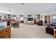 Open-concept living area with bar, television, and leather reclining sofa at 7024 Sw 93Rd Street Rd, Ocala, FL 34476