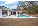 Backyard pool with an umbrella table and chairs, the perfect place for outdoor relaxing and entertaining at 7024 Sw 93Rd Street Rd, Ocala, FL 34476