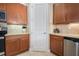 Modern kitchen with wood cabinets and a large pantry at 791 Aldenham Ln, Ormond Beach, FL 32174