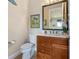 Small bathroom with toilet and a wood vanity at 990 Downshire Ln, Ormond Beach, FL 32174