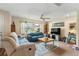 Living room with teal sofa, beige sofa, and a ceiling fan at 1031 Calle Grande St, Ormond Beach, FL 32174