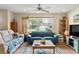 Bright living room with two sofas, coffee table, and TV stand at 1031 Calle Grande St, Ormond Beach, FL 32174