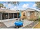 Outdoor patio with a table and umbrella, a screened-in porch and a shed with a porch at 1031 Calle Grande St, Ormond Beach, FL 32174