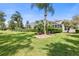 Landscaped backyard with lush lawn and screened enclosure at 1068 Hampstead Ln, Ormond Beach, FL 32174