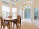 Bright dining room with wood table and chairs, near the entryway at 1068 Hampstead Ln, Ormond Beach, FL 32174