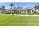 Gray house with lush lawn, palm trees, and walkway at 1068 Hampstead Ln, Ormond Beach, FL 32174