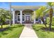 Elegant entryway with red door and columns at 1068 Hampstead Ln, Ormond Beach, FL 32174