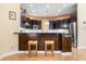 Modern kitchen with dark wood cabinets and a breakfast bar at 1068 Hampstead Ln, Ormond Beach, FL 32174