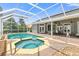 Refreshing pool and spa with brick deck and screened enclosure at 1068 Hampstead Ln, Ormond Beach, FL 32174