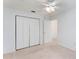 Bedroom with large closet and ceiling fan at 11977 Se 91St Cir, Summerfield, FL 34491