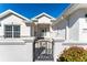 House exterior showcasing a decorative gate and well-maintained landscaping at 11977 Se 91St Cir, Summerfield, FL 34491