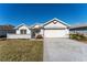 House exterior with driveway and landscaping at 11977 Se 91St Cir, Summerfield, FL 34491