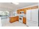 Kitchen features wood cabinets and white appliances at 11977 Se 91St Cir, Summerfield, FL 34491