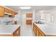 Kitchen features light wood cabinets and tile flooring at 11977 Se 91St Cir, Summerfield, FL 34491