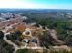 An aerial view shows this home nestled amongst trees in a rural community with ample green space at 211 Oak Lane Loop, Ocala, FL 34472