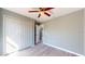 Bedroom with wood-look floors and a double-door closet at 211 Oak Lane Loop, Ocala, FL 34472