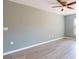 A spacious bedroom boasts neutral walls, modern ceiling fan, and wood-look flooring at 211 Oak Lane Loop, Ocala, FL 34472