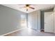 Bright bedroom featuring wood-look floors, a ceiling fan, and a double-door closet at 211 Oak Lane Loop, Ocala, FL 34472