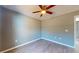 Cozy bedroom with ceiling fan, wood-look floors, and ample natural light at 211 Oak Lane Loop, Ocala, FL 34472