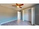 Bedroom with ceiling fan, closet, and wood-look floors at 211 Oak Lane Loop, Ocala, FL 34472