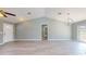 Open living room with vaulted ceilings, wood-look floors, and natural light from surrounding windows at 211 Oak Lane Loop, Ocala, FL 34472