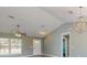 Bright living room with modern fixtures, large windows and view into the dining area at 211 Oak Lane Loop, Ocala, FL 34472