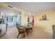 Small dining area with glass-top table and wicker chairs at 3100 Ocean Shore Blvd # 5020, Ormond Beach, FL 32176