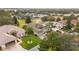 Aerial view of a residential neighborhood with houses and palm trees at 4546 Nottoway Dr, Leesburg, FL 34748