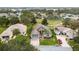 An aerial view of a house nestled in a neighborhood near a golf course at 4546 Nottoway Dr, Leesburg, FL 34748