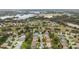 Aerial view of a residential community featuring numerous homes and a golf course at 4546 Nottoway Dr, Leesburg, FL 34748