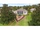 Backyard view of a home showcasing a triangular garden at 4546 Nottoway Dr, Leesburg, FL 34748