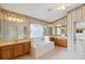 Main bathroom with double vanity, bathtub and shower at 4546 Nottoway Dr, Leesburg, FL 34748