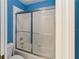 Bathroom with shower/tub combo and sliding glass door at 4546 Nottoway Dr, Leesburg, FL 34748