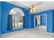 Spacious bedroom featuring blue walls, mirrored closet doors, and a large window at 4546 Nottoway Dr, Leesburg, FL 34748