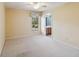 Light beige bedroom with a ceiling fan and window at 4546 Nottoway Dr, Leesburg, FL 34748