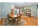 Open concept dining area with hardwood floors and chandelier at 4546 Nottoway Dr, Leesburg, FL 34748