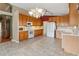 Kitchen with wood cabinets, tile flooring, and white appliances at 4546 Nottoway Dr, Leesburg, FL 34748