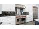 High-end stainless steel range and white cabinetry in this modern kitchen at 59 Cunningham Dr, New Smyrna Beach, FL 32168