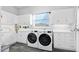 Bright laundry room with washer, dryer, and white cabinets at 59 Cunningham Dr, New Smyrna Beach, FL 32168