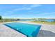 Inviting rectangular pool with grey pavers and water views at 59 Cunningham Dr, New Smyrna Beach, FL 32168