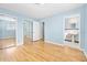 Bedroom with hardwood floors, mirrored closet, and ensuite bathroom at 142 Seton Trl, Ormond Beach, FL 32176