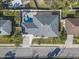 Overhead aerial view of a home with a driveway and backyard pool at 149 Sunrise Cove Cir, Ormond Beach, FL 32176