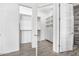 Spacious walk-in closet with custom shelving and wood flooring at 149 Sunrise Cove Cir, Ormond Beach, FL 32176