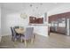 Kitchen and dining area with modern cabinetry and granite countertops at 149 Sunrise Cove Cir, Ormond Beach, FL 32176