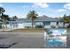 Newly renovated light blue home with a two-car garage, palm trees, and a spacious yard at 149 Sunrise Cove Cir, Ormond Beach, FL 32176