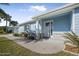 Front view of a charming light blue house with a walkway and landscaping at 149 Sunrise Cove Cir, Ormond Beach, FL 32176